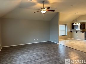 Oklahoma City house for rent - A room with a chandelier, tiled floor, and a window with blinds.