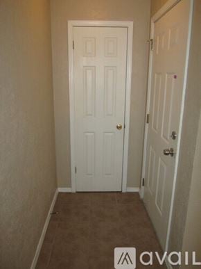 Oklahoma City house for rent - A white door is in a room with carpeted flooring.