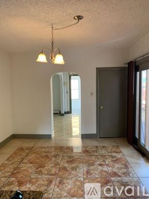 Worcester townhouse for rent - A room with a tiled floor and a chandelier.