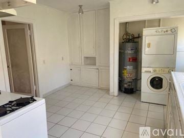 Los Angeles house for rent - A kitchen with white cabinets and a white stove.