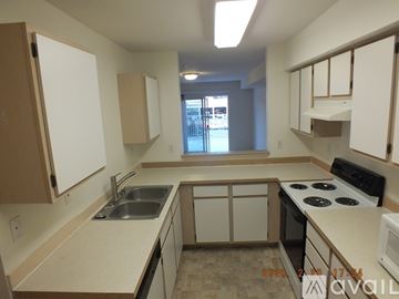 Seattle apartment for rent - A kitchen with white cabinets and a stove top oven.