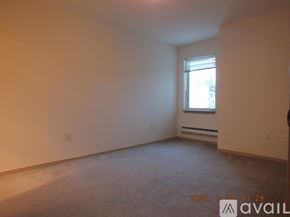 Seattle apartment for rent - A room with a window and a carpeted floor.