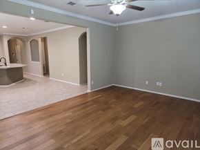 Leander house for rent - A spacious room with wooden flooring and a ceiling fan.