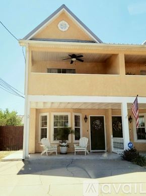 Panama City Beach townhouse for rent - A house with a balcony and a fan on the roof.