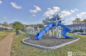 Nashville apartment for rent - A playground with a blue slide and a wooden structure.