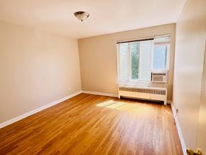 Washington Dc apartment for rent - A room with wooden flooring and a window with blinds.