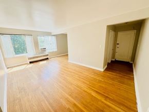Washington Dc apartment for rent - A room with wooden floors and white walls.