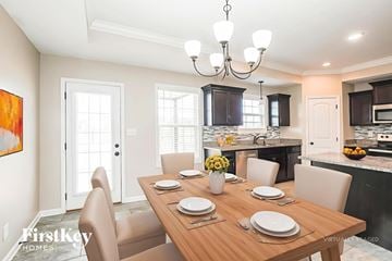 Clarksville house for rent - A dining room with a wooden table set for a meal.