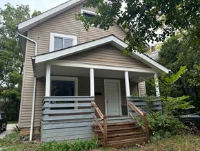 Akron house for rent - A small house with a porch and a white door.