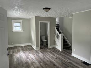 Akron house for rent - A room with a staircase and a toilet.