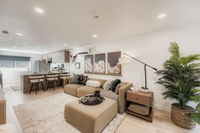 Salt Lake City townhouse for rent - A living room with a couch, a table, and a plant.