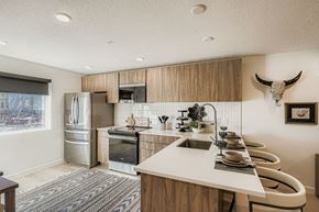Salt Lake City townhouse for rent - A modern kitchen with a long white counter and a cow skull on the wall.