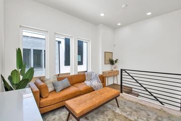 Salt Lake City apartment for rent - A living room with a brown leather couch and a wooden coffee table.