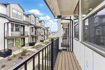 Bend apartment for rent - A row of modern townhouses with balconies and black railings.