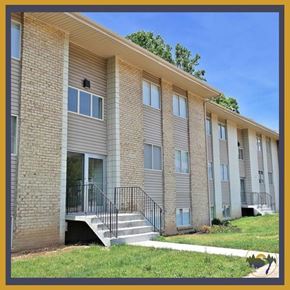 Dayton apartment for rent - A building with a balcony and a staircase leading to the entrance.