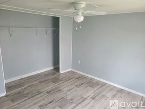 Dublin apartment for rent - A room with a ceiling fan and a doorway leading to another room.