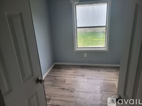 Dublin apartment for rent - A room with a door and a window showing a grassy area outside.