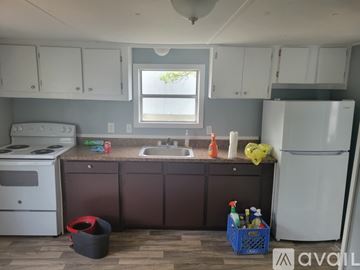 Dublin apartment for rent - A kitchen with a white refrigerator, a white stove, and brown cabinets.
