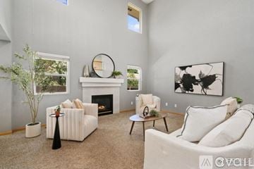 Fort Collins house for rent - A living room with a fireplace, two couches, and a painting on the wall.