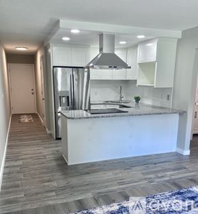 Shakopee apartment for rent - A modern kitchen with a white island and stainless steel appliances.