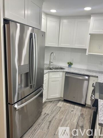 Shakopee apartment for rent - A kitchen with a stainless steel refrigerator and a sink.