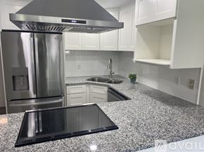 Shakopee apartment for rent - A kitchen with granite countertops and a stainless steel refrigerator.
