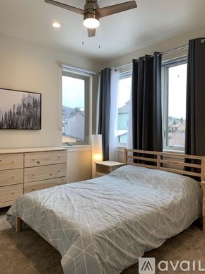 Silverthorne apartment for rent - A bedroom with a bed, dresser, and window with black curtains.
