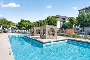 Atlanta apartment for rent - A pool with a blue tinted water and a sculpture in the middle.