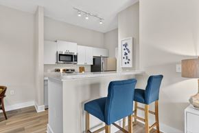Atlanta apartment for rent - A kitchen with a white counter and blue chairs.