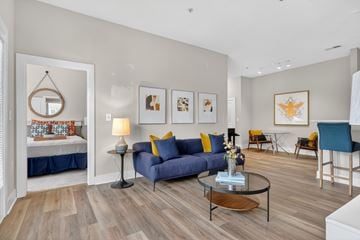 Atlanta apartment for rent - A living room with a blue couch and a coffee table.