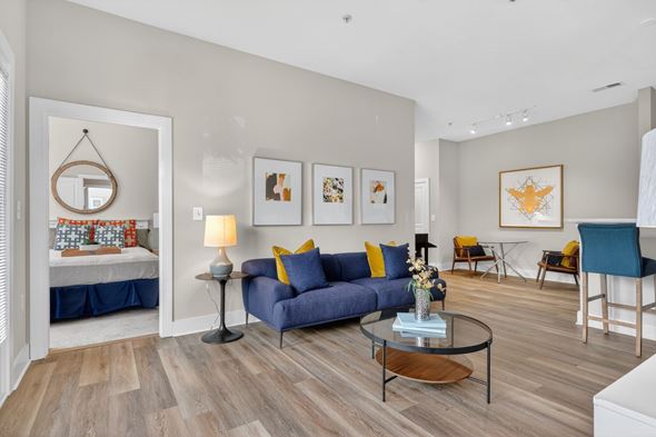 Atlanta apartment for rent - A living room with a blue couch and a coffee table.
