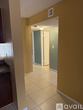 Tamarac house for rent - A hallway with a door on the right and a counter on the left.
