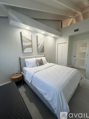 Little Torch Key apartment for rent - A bedroom with a large bed and two pictures on the wall.