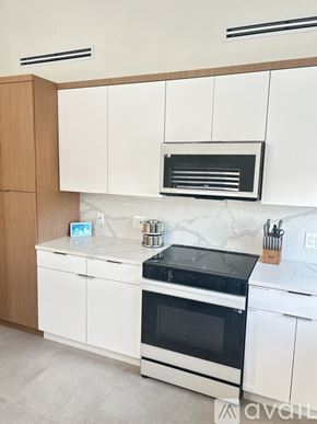 Little Torch Key apartment for rent - A kitchen with white cabinets and a black stove top.
