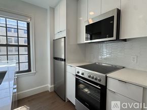 Cambridge apartment for rent - A kitchen with a stainless steel refrigerator, oven, and microwave.