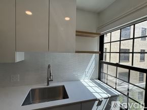 Cambridge apartment for rent - A modern kitchen with a stainless steel sink and white cabinets.