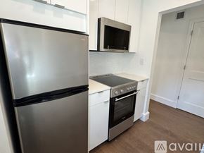Cambridge apartment for rent - A kitchen with a stainless steel refrigerator, microwave, and oven.
