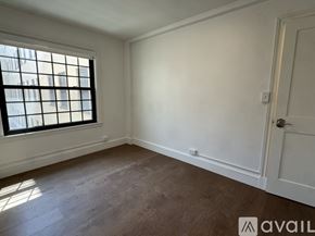 Cambridge apartment for rent - A room with a window and wooden flooring.