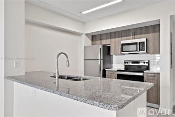Doral apartment for rent - A kitchen with granite countertops and stainless steel appliances.