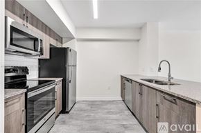 Doral apartment for rent - A kitchen with a black refrigerator, stove, and oven.