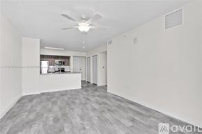 Doral apartment for rent - A spacious room with a ceiling fan and a grey floor.