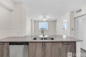 Doral apartment for rent - A kitchen with a granite countertop and stainless steel appliances.