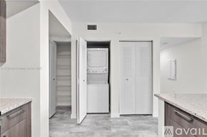 Doral apartment for rent - A kitchen with a white fridge and cabinets.