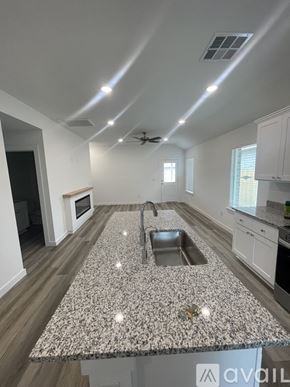 Lubbock house for rent - A kitchen with a granite countertop and a sink.