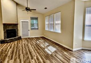 Camdenton house for rent - A living room with a fireplace and wood flooring.