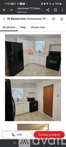 Hempstead house for rent - A black refrigerator and oven in a kitchen with white cabinets.