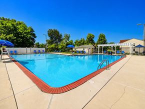Lumberton apartment for rent - A large outdoor swimming pool with a red and blue border.