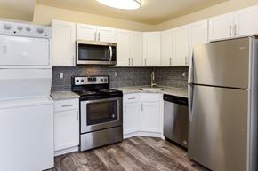 Lumberton apartment for rent - a kitchen with stainless steel appliances and white cabinets