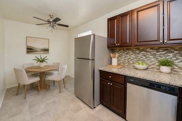 Voorhees apartment for rent - A kitchen with a refrigerator, dishwasher, and table.