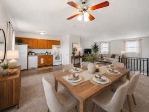Vineland apartment for rent - A dining room with a table set for six with a fan in the ceiling.